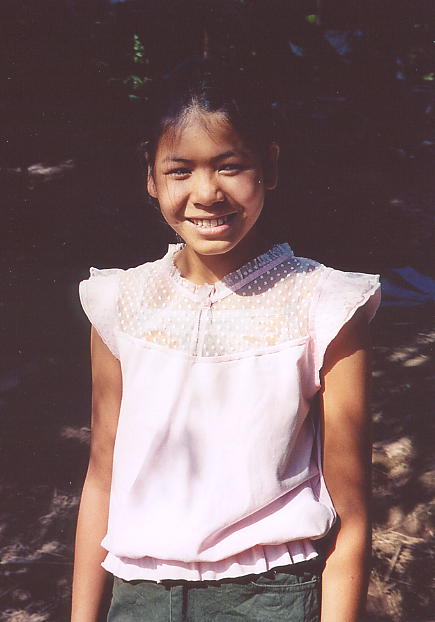 A beaming Vansy at home in Kien Svay. She's proudly wearing a top that my wife bought her {click to enlarge}.